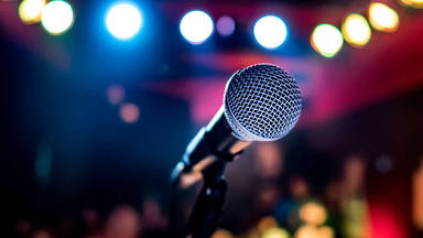 Microphone on stage against a background of auditorium.